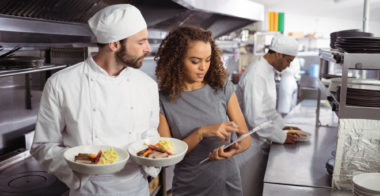 Chefs discussing how to reduce food waste Chefs discussing how to reduce food waste in commercial kitchen