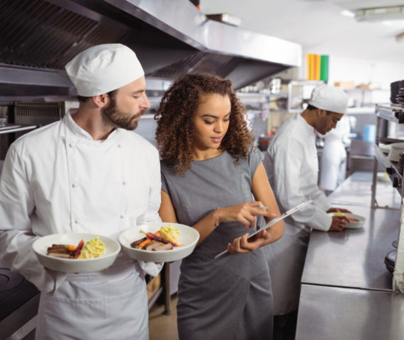 Chefs discussing how to reduce food waste Chefs discussing how to reduce food waste in commercial kitchen