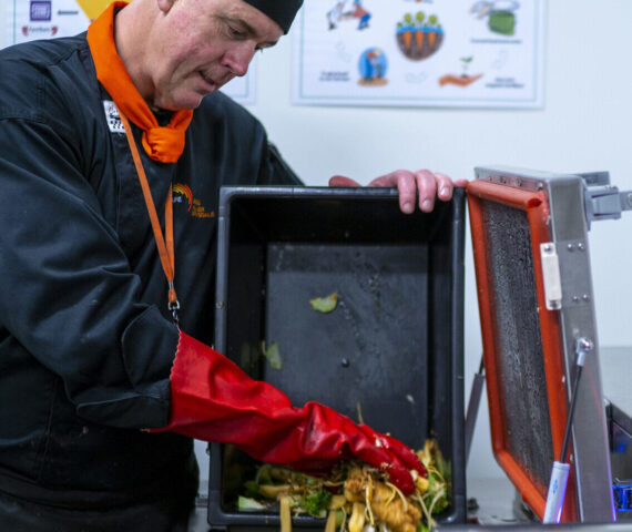 Image of composter being filled with food waste