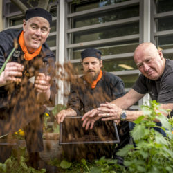 Image of staff at Drysdale North spreading compost on a kitchen garden