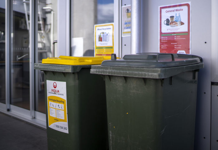 Image of co-mingled recycling bins on a balcony