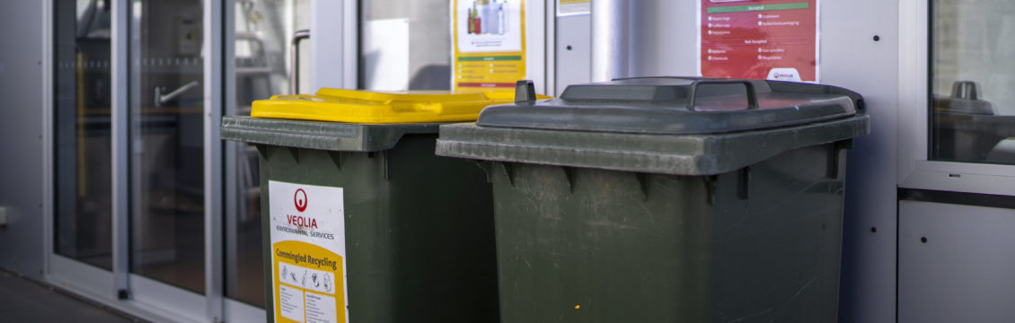 Image of co-mingled recycling bins on a balcony